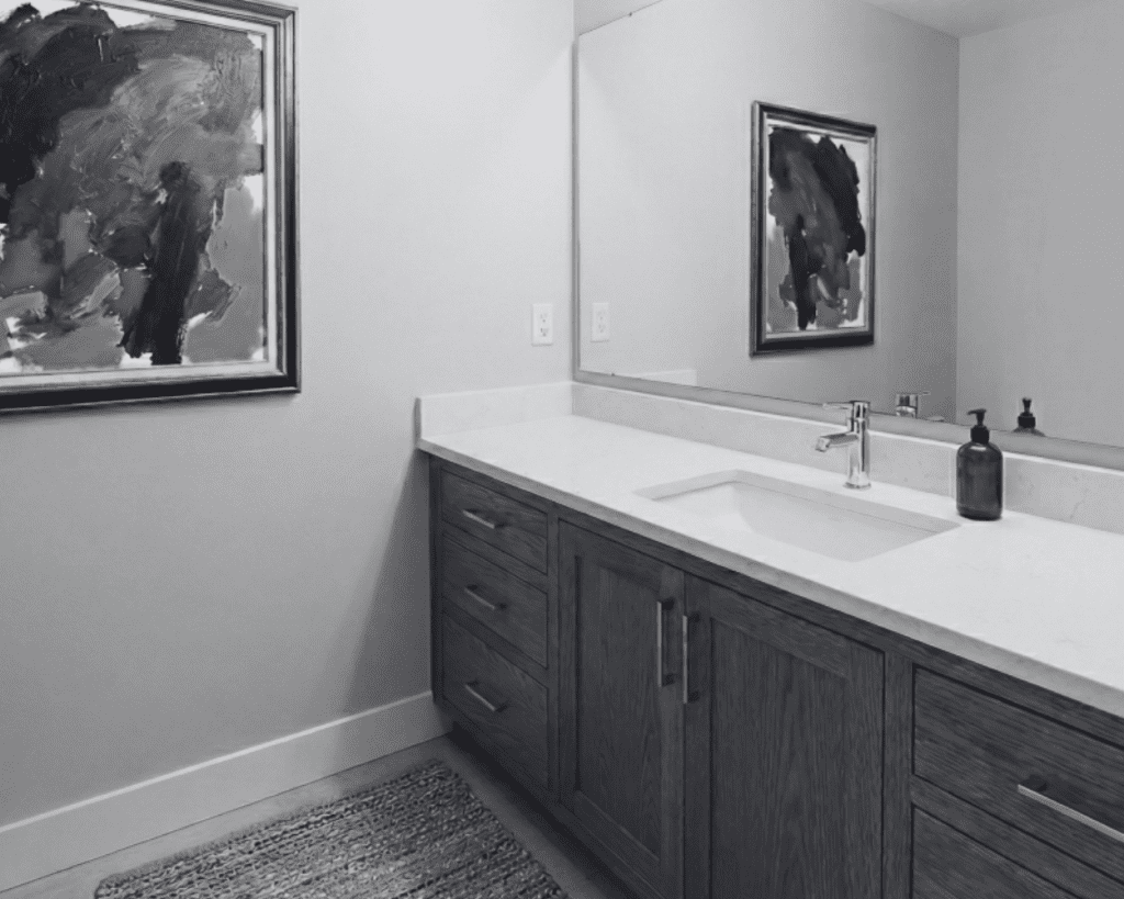 Wood vanity paired with colorful artwork that inspired the bathroom palette