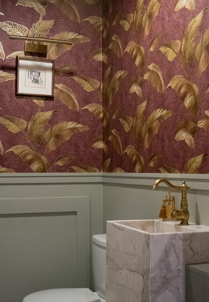 Powder room with floral wallpaper and marble sink